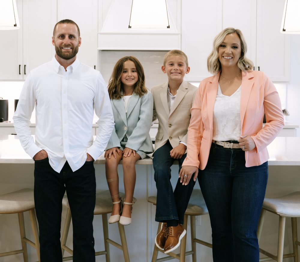 Wesley and Kristen Furbay with their son and daughter in a bright kitchen
