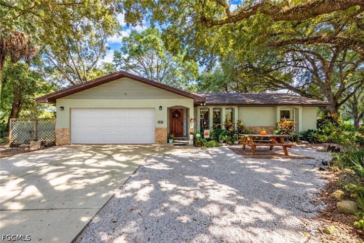 Home under oak trees at 1816 Grant Avenue in Lehigh Acres
