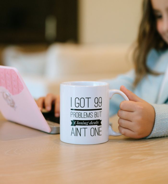 Their daughter with a mug that says I got 99 problems but closing deals ain't one
